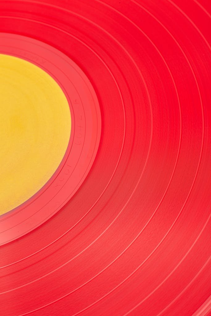 Vibrant red and yellow close-up of a vinyl record, perfect for music and design themes.